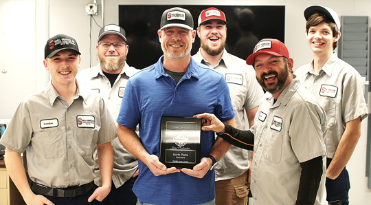 Snell Services team holds BusinessRate Best HVAC Contractor in North Platte for 2025 plaque.